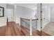 Upstairs hallway with gleaming hardwood flooring, classic white trim, and a view of the open staircase at 2254 Beckenham Dr, Mount Pleasant, SC 29466