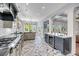 Bright kitchen with stainless appliances, brick flooring, and windows overlooking backyard at 2254 Beckenham Dr, Mount Pleasant, SC 29466