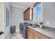 Functional laundry room with modern washer/dryer, granite countertops, and window at 2254 Beckenham Dr, Mount Pleasant, SC 29466