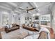 Bright, open-concept living space with coffered ceilings, a ceiling fan, and seamless transitions to the kitchen area at 2254 Beckenham Dr, Mount Pleasant, SC 29466