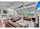 Open living room with coffered ceilings, ceiling fan, fireplace, leather sofas, and seamless access to the kitchen at 2254 Beckenham Dr, Mount Pleasant, SC 29466