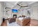Comfortable living room with a brick fireplace, built-in shelves, hardwood floors, and plenty of natural light at 2254 Beckenham Dr, Mount Pleasant, SC 29466