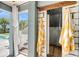 Outdoor shower featuring corrugated metal and yellow striped towels with a view of the backyard pool area at 2254 Beckenham Dr, Mount Pleasant, SC 29466