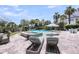 Backyard pool area with lounge chairs, umbrella, and hot tub features lush landscaping at 2254 Beckenham Dr, Mount Pleasant, SC 29466
