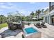 Outdoor patio featuring a pool, lounge chairs, a dining area, a modern fire pit, and beautifully landscaped surroundings at 2254 Beckenham Dr, Mount Pleasant, SC 29466