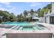 Resort-style pool and hot tub surrounded by lush landscaping and a charming blue and white house at 2254 Beckenham Dr, Mount Pleasant, SC 29466