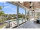 Spacious screened porch overlooking landscaped yard, pool, and waterfront at 2254 Beckenham Dr, Mount Pleasant, SC 29466