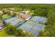 Overhead view of pristine tennis courts with blue surfaces, framed by lush greenery and community buildings at 2254 Beckenham Dr, Mount Pleasant, SC 29466