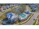Aerial view of a community pool and clubhouse surrounded by lush landscaping and homes at 2636 Colonel Harrison Dr, Johns Island, SC 29455