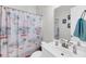 Bathroom with white vanity, palm tree themed shower curtain, and silver faucet at 2636 Colonel Harrison Dr, Johns Island, SC 29455