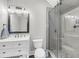 Stylish bathroom featuring vanity with sleek fixtures, framed mirror, sliding glass shower, and modern tiling at 2636 Colonel Harrison Dr, Johns Island, SC 29455