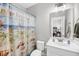 Bathroom with white vanity, beach themed shower curtain, and silver faucet at 2636 Colonel Harrison Dr, Johns Island, SC 29455