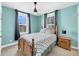 Bedroom with aqua walls, carpeted floors, wood furniture, and two windows at 2636 Colonel Harrison Dr, Johns Island, SC 29455