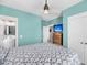 Light-filled bedroom features stylish decor, calming paint, dresser with TV, and convenient ensuite bathroom access at 2636 Colonel Harrison Dr, Johns Island, SC 29455