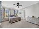 Bright bedroom features a ceiling fan, neutral walls, plush carpet, and natural light from windows with modern curtains at 2636 Colonel Harrison Dr, Johns Island, SC 29455