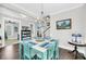 Bright dining room featuring an elegant chandelier and access to the living area at 2636 Colonel Harrison Dr, Johns Island, SC 29455