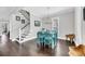 Bright dining room with hardwood floors, staircase, and a charming table set for six at 2636 Colonel Harrison Dr, Johns Island, SC 29455