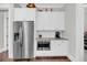 Kitchenette area with stainless steel refrigerator and white cabinets for ample storage at 2636 Colonel Harrison Dr, Johns Island, SC 29455