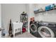 Functional laundry room with modern washer and dryer, storage shelves, and utility sink at 2636 Colonel Harrison Dr, Johns Island, SC 29455