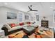 Bright living room features a large sectional sofa, a ceiling fan, neutral walls, natural light and modern décor at 2636 Colonel Harrison Dr, Johns Island, SC 29455