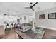 Bright living room featuring hardwood floors, modern ceiling fan, and open concept kitchen at 2636 Colonel Harrison Dr, Johns Island, SC 29455