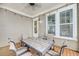Charming outdoor dining area on porch, featuring a tile-top table and comfortable seating under a sheltered ceiling at 2636 Colonel Harrison Dr, Johns Island, SC 29455