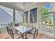 Inviting screened-in porch with outdoor dining set, perfect for entertaining or relaxing in a comfortable setting at 2636 Colonel Harrison Dr, Johns Island, SC 29455