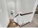 Elegant staircase with wooden steps, white railings, and modern lighting, creating a seamless transition between floors at 2636 Colonel Harrison Dr, Johns Island, SC 29455