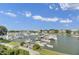 Scenic aerial view of a marina filled with boats and surrounded by waterfront homes against a blue sky at 30 Yacht Harbor Ct, Isle of Palms, SC 29451