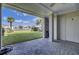 Covered outdoor patio area with palm tree views, ideal for relaxing and entertaining guests at 30 Yacht Harbor Ct, Isle of Palms, SC 29451