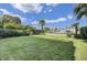 Lush green backyard with palm trees at 30 Yacht Harbor Ct, Isle of Palms, SC 29451