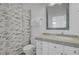Well-lit bathroom with a patterned shower curtain, a vanity with framed mirror, and white cabinets at 30 Yacht Harbor Ct, Isle of Palms, SC 29451