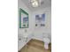 Modern half bath with a floating sink, artistic mirror, and stylish decor creating a unique look at 30 Yacht Harbor Ct, Isle of Palms, SC 29451