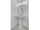 Bright bathroom featuring a pedestal sink with a decorative mirror, offering a clean and minimalist design at 30 Yacht Harbor Ct, Isle of Palms, SC 29451