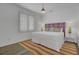 Bright bedroom featuring a large window, a bed with colorful pillows, and a striped rug at 30 Yacht Harbor Ct, Isle of Palms, SC 29451