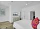 Bright bedroom featuring a large window, TV, and hardwood floors at 30 Yacht Harbor Ct, Isle of Palms, SC 29451
