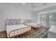 A bedroom with two twin beds, hardwood floors, and french doors at 30 Yacht Harbor Ct, Isle of Palms, SC 29451