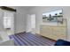 Bright bedroom with a striped rug, wooden dresser, and doorway to the main bedroom at 30 Yacht Harbor Ct, Isle of Palms, SC 29451