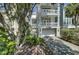 Elegant three-story home with multiple balconies, a garage, and mature trees at 30 Yacht Harbor Ct, Isle of Palms, SC 29451