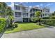Beautifully landscaped home with multiple balconies, a lush lawn, and mature palm trees at 30 Yacht Harbor Ct, Isle of Palms, SC 29451