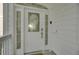 Elegant front door with decorative glass, side windows, and white trim, creating a welcoming entrance at 30 Yacht Harbor Ct, Isle of Palms, SC 29451