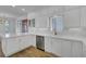 Bright kitchen features white cabinets, tiled backsplash, stainless steel appliances and hardwood floors at 30 Yacht Harbor Ct, Isle of Palms, SC 29451