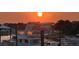 Marina at sunset with yachts, boats, and waterfront buildings, creating a tranquil coastal ambiance at 30 Yacht Harbor Ct, Isle of Palms, SC 29451