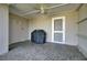 Covered patio with stone flooring, ceiling fan, grill, and easy access to the outdoors at 30 Yacht Harbor Ct, Isle of Palms, SC 29451