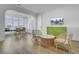Bright and airy living space with bamboo furniture, TV, and beautiful views from the large windows at 30 Yacht Harbor Ct, Isle of Palms, SC 29451