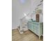 Elegant staircase with hardwood floors, white railings, and a stylish console table, adding charm at 30 Yacht Harbor Ct, Isle of Palms, SC 29451