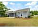 Beautiful backyard features a screened porch, lush green lawn, and mature landscaping for outdoor enjoyment at 3061 Cross Vine Ln, Summerville, SC 29483