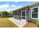 Spacious backyard featuring a screened porch and well-manicured lawn perfect for outdoor activities at 3061 Cross Vine Ln, Summerville, SC 29483