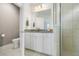 Stylish bathroom featuring white cabinets, granite counters, tiled floors, and glass shower at 3061 Cross Vine Ln, Summerville, SC 29483