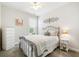Cozy bedroom features a neutral color palette, an iron bed frame, a dresser, and natural light from the window at 3061 Cross Vine Ln, Summerville, SC 29483